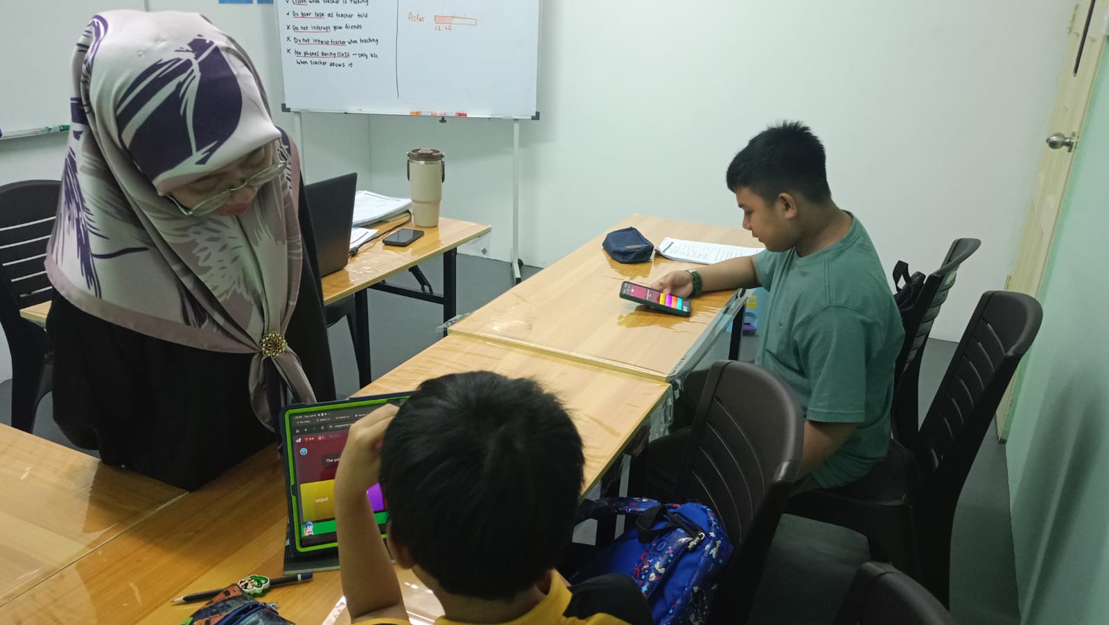 An AFTC tutor guiding students through an interactive classroom activity